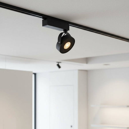 black track lighting fitting mounted on the ceiling in an office