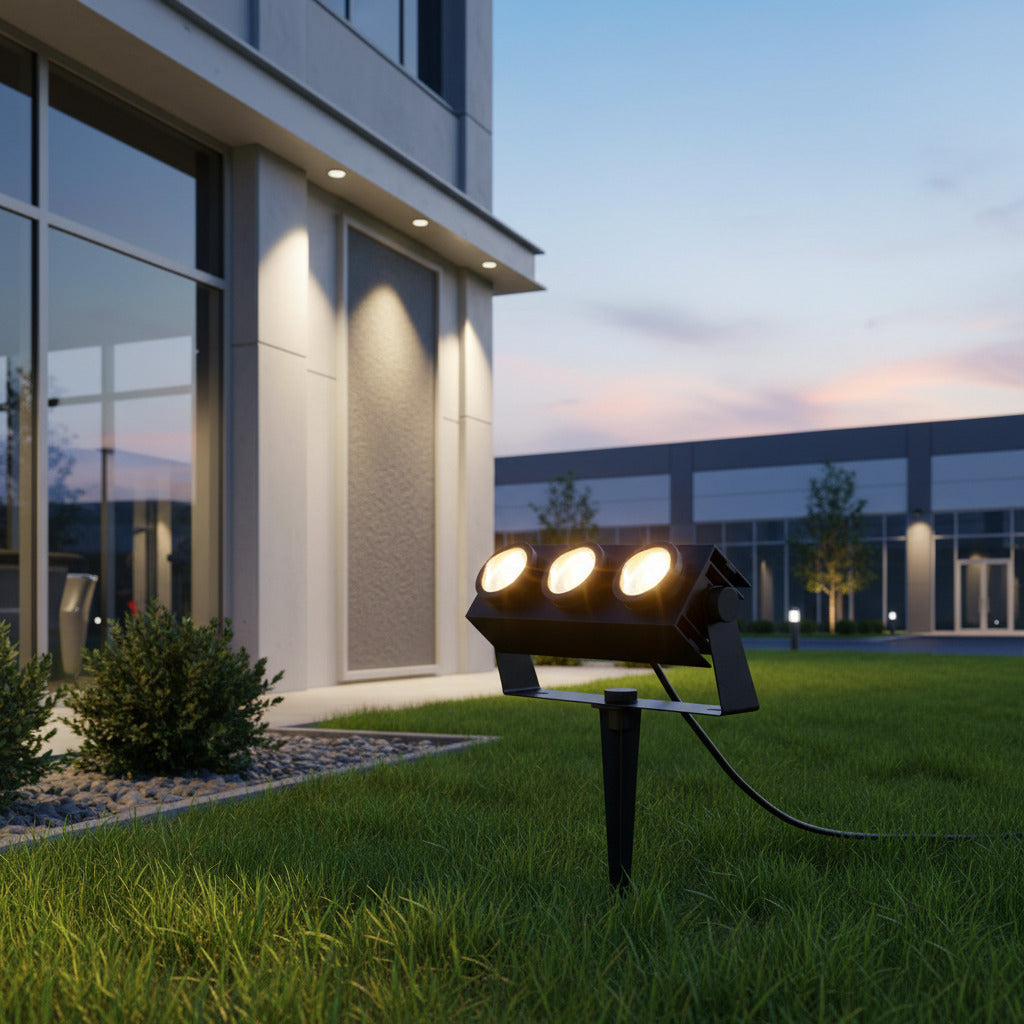 black mains powered spike light installed on the lawn outside a commercial building 