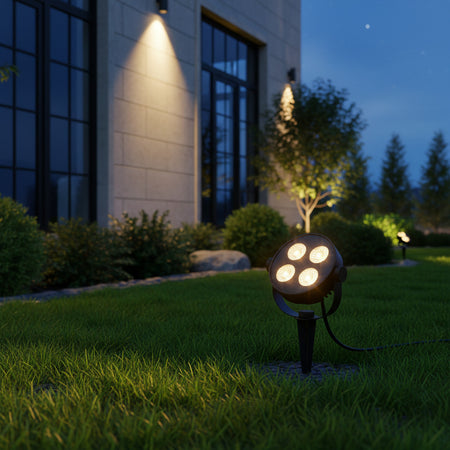 black electric garden spike light illuminating the outside of a commercial building