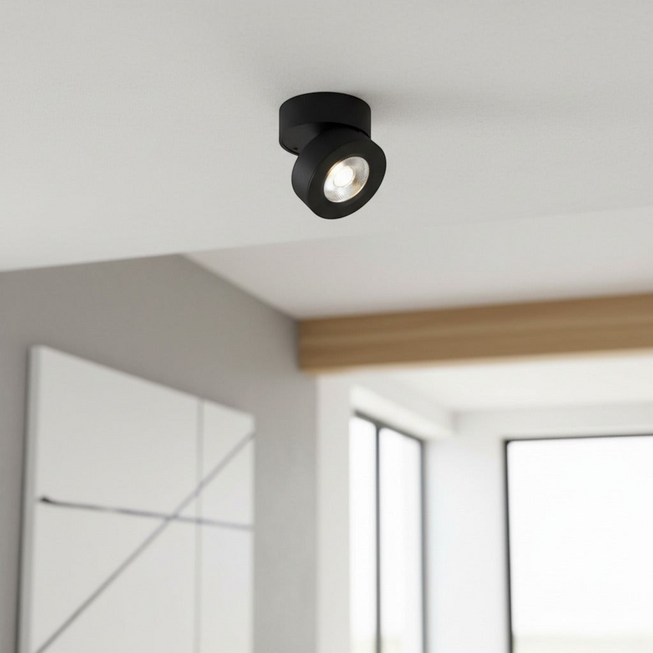 black adjustable surface mounted downlight on the ceiling of a modern home