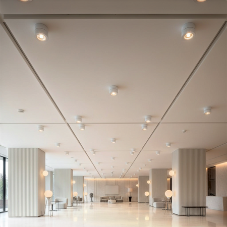 white adjustable ceiling light mounted on a high ceiling in a hotel