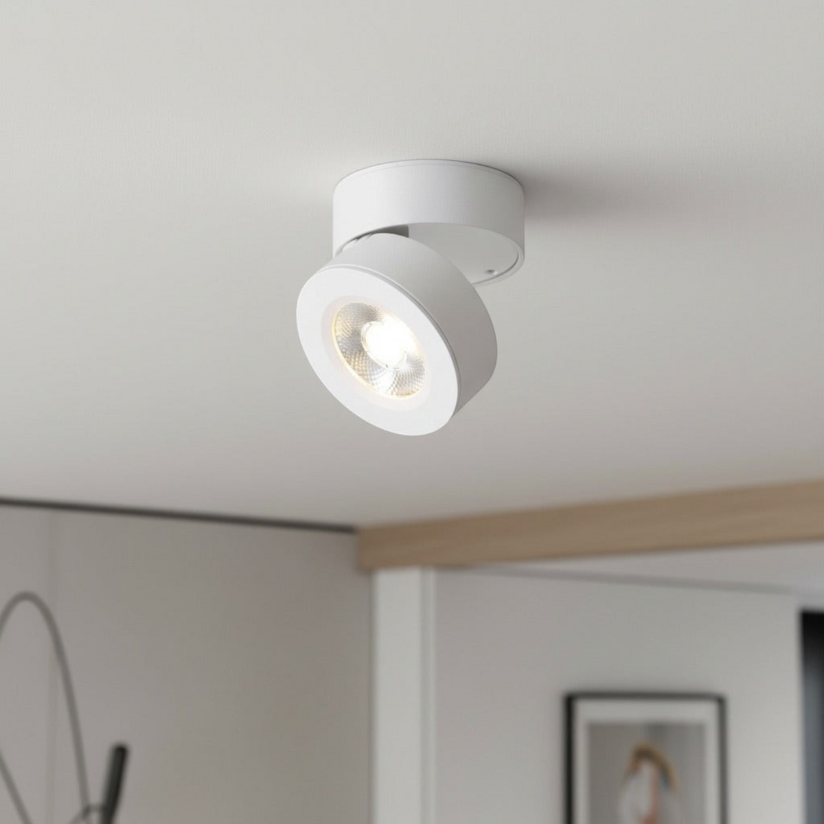 white adjustable ceiling light mounted on a white ceiling in a modern home