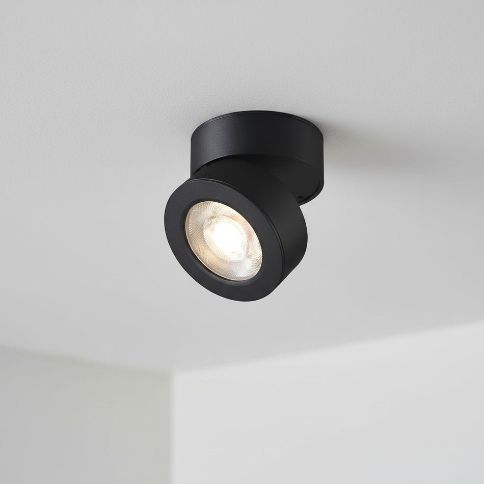 black adjustable ceiling lamp installed on a white ceiling in a house