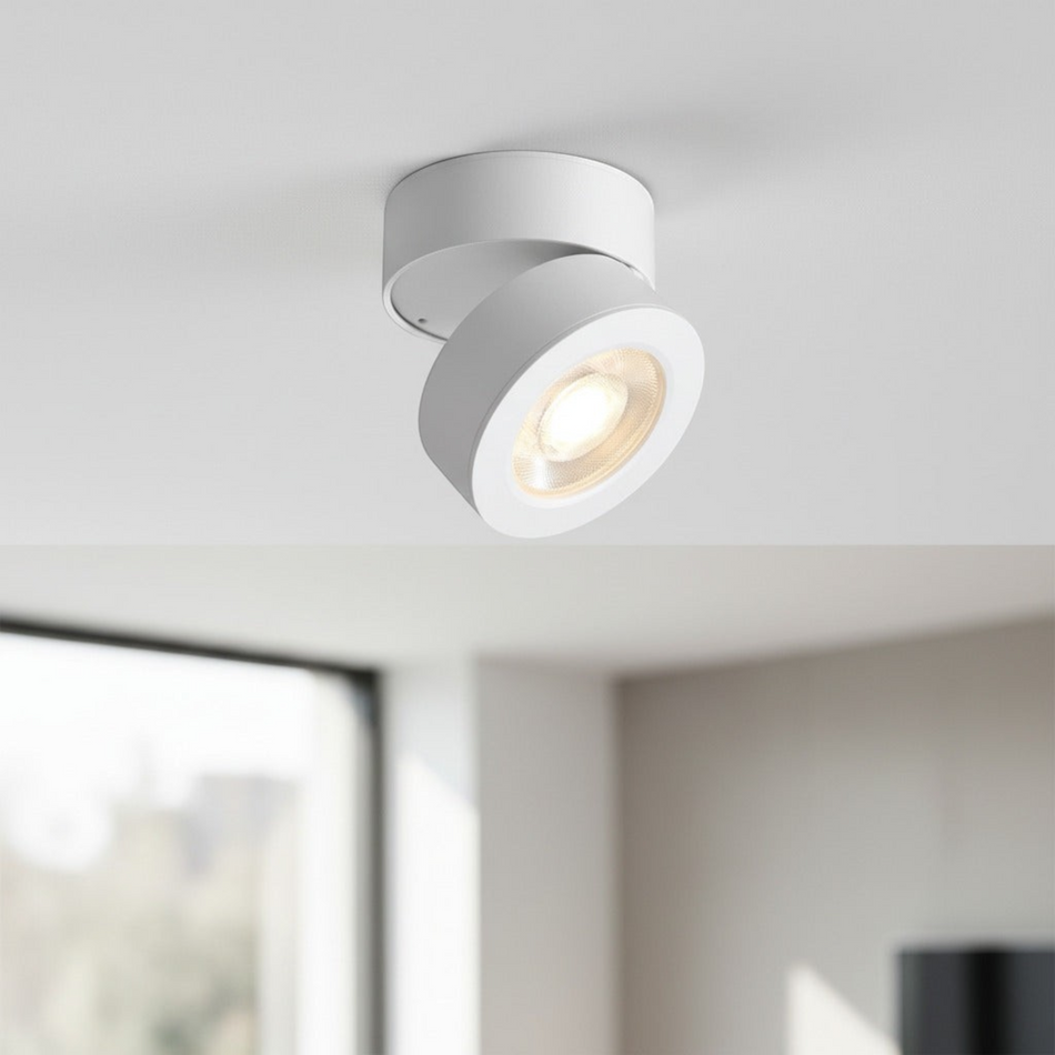 white surface mount adjustable spotlight mounted in a house on a white ceiling