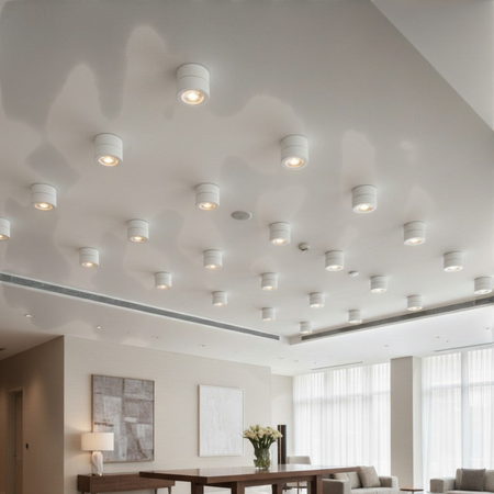 white surface mount adjustable spotlight mounted on the ceiling in a hotel reception area