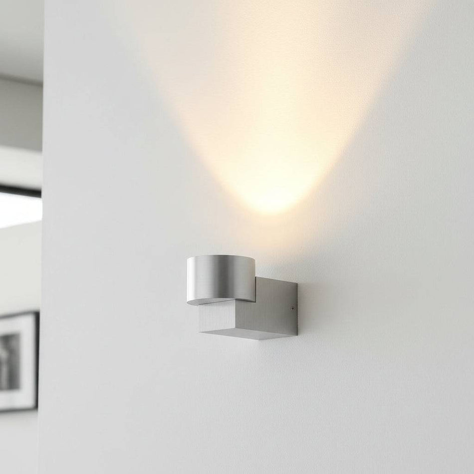 Silver indoor wall uplight in a modern home on a grey wall