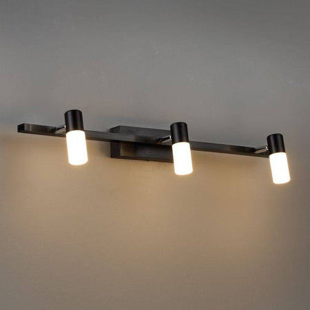 black vanity light over mirror mounted on a grey wall 