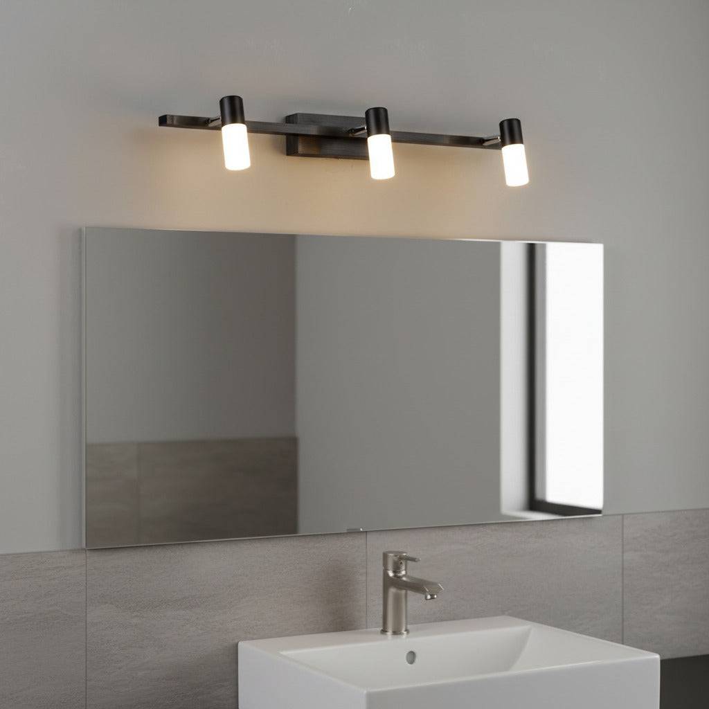 black vanity light over mirror mounted on the wall in a modern bathroom