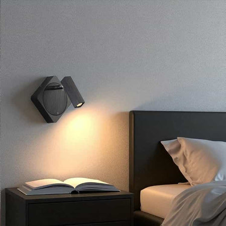 black wall reading light mounted on the wall next to the bed in a modern bedroom