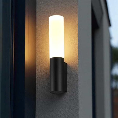 black lantern outdoor light moounted on a white textured wall outside a modern house