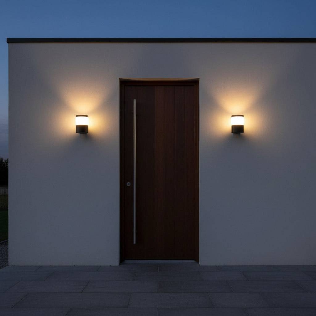 black outside wall lantern mounted either side of a wooden front entrance door 