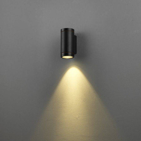 black outdoor LED wall downlight shown on a white wall 