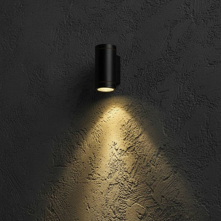 black outdoor LED wall downlight mounted on a textured exterior wall 