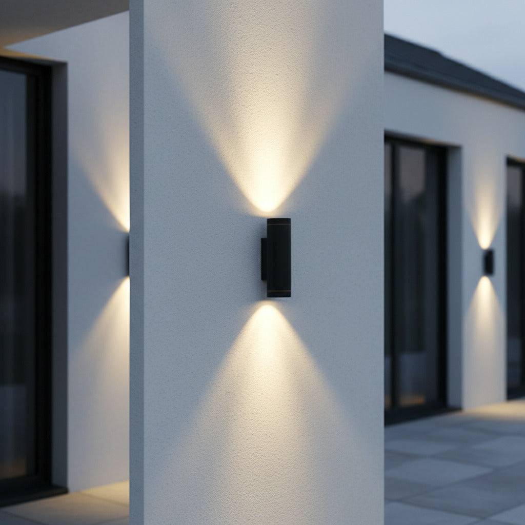 black outside up and down light mounted on a white column outside a modern house 