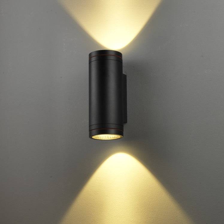 black large outdoor wall light shown mounted on a white wall 