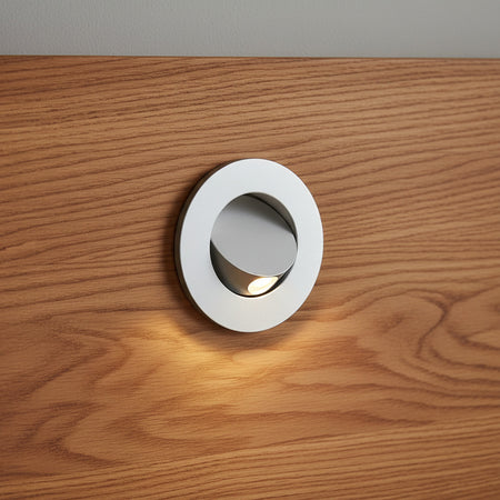 silver recessed wall or bed headboard reading light mouonted on a wooden headboard