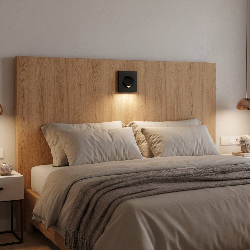 black recessed LED reading lamp for bed recessed into a wooden headboard over a bed in a modern bedroom