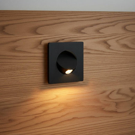 black recessed LED reading lamp for bed recessed into a wooden bed headboard