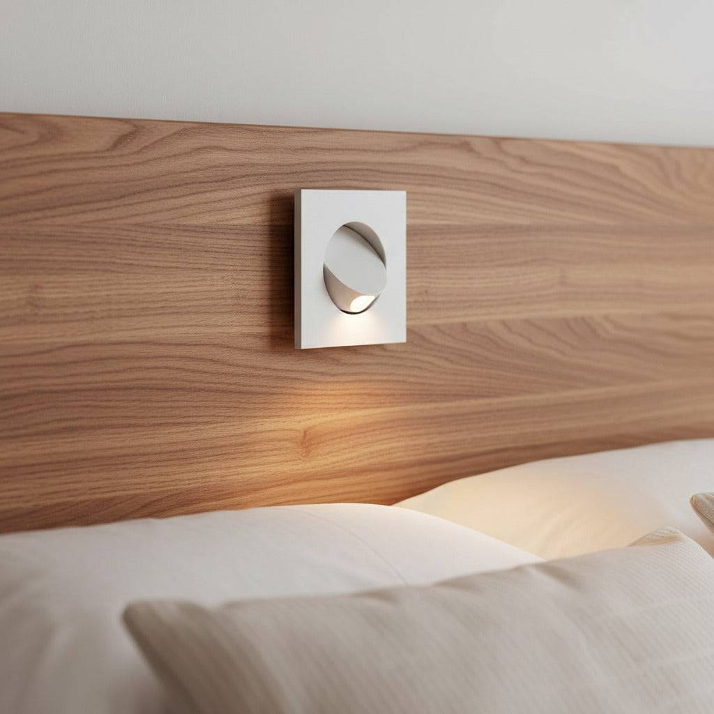 white recessed LED reading light for bed recessed into a wooden bed headboard in a minimailst bedroom