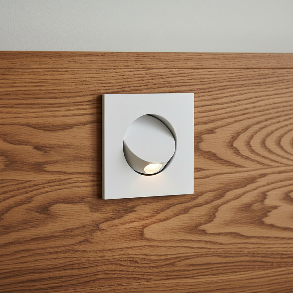 white recessed LED reading light for bed mounted in a wooden headboard
