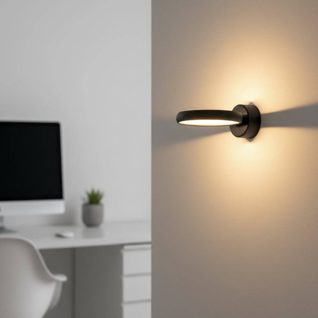 Black internal wall light on a grey wall next to a desk in a modern family home