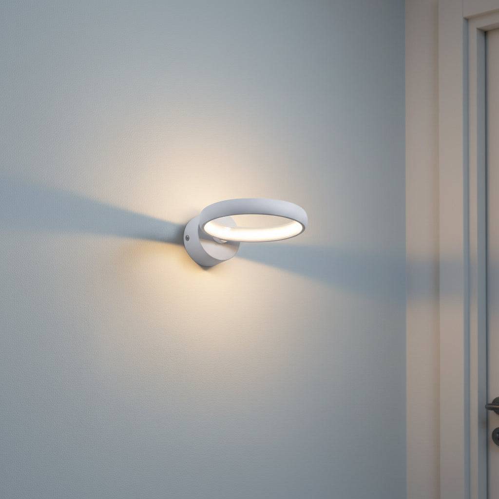 White indoor LED sconce light on a pale blue wall in a hallway