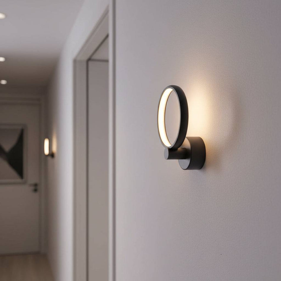 Black LED indoor wall lamp in a hallway of a modern home