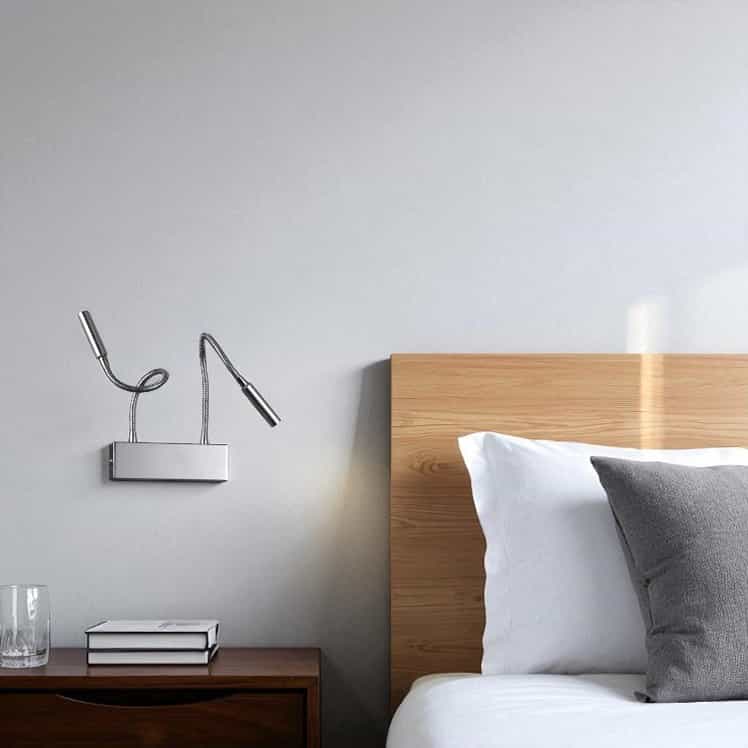 polished chrome over bed reading light mounted next to a bed in a modern bedroom