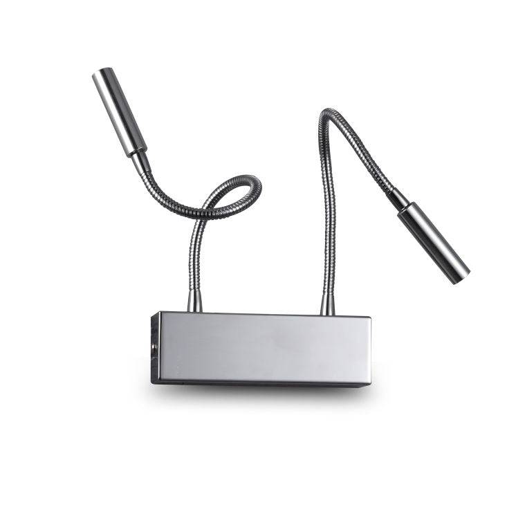 chrome over bed reading light mounted on a white wall
