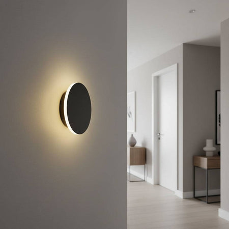 Modern black wall sconce on the wall of a hallway in a modern home