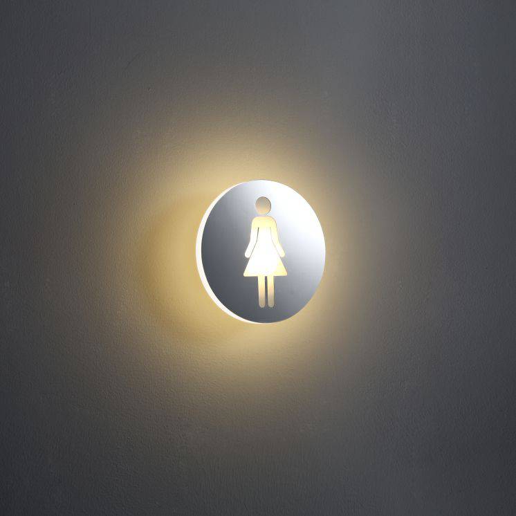 illuminated ladies toilet sign mounted on a white wall 