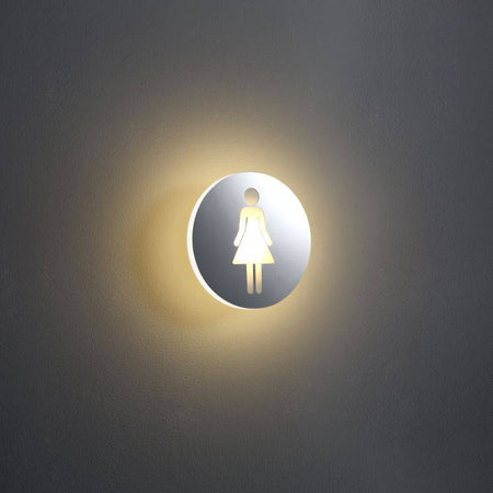illuminated ladies toilet sign mounted on a white wall 