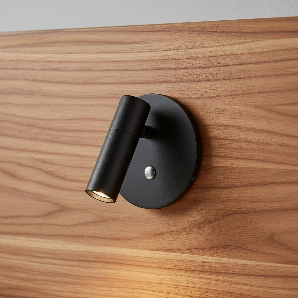 black recessed adjustable bed reading light mounted on a wooden headboard