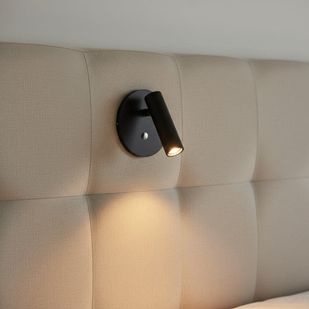 black recessed adjustable bed reading light mounted on a fabric headboard