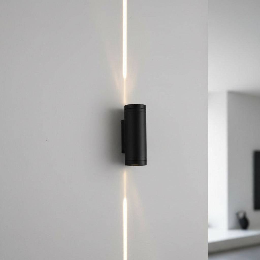 black up and down outside light mounted on a white wall on the exterior of a house