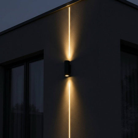 black up and down outside light mounted on a white wall on the exterior of a modern house 