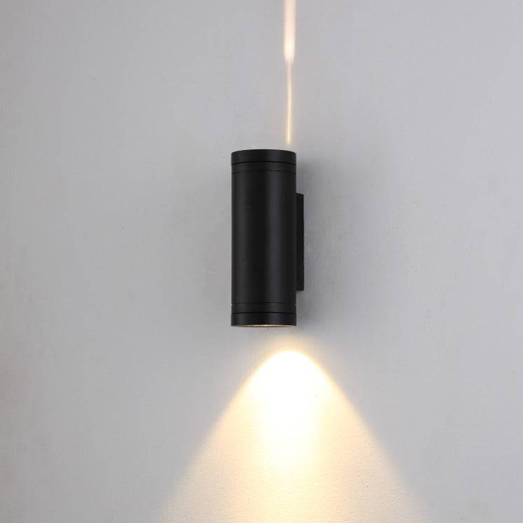 black up and down light mounted on a white wall 