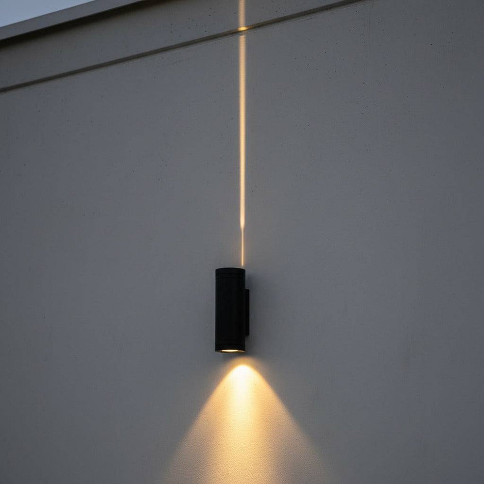 black up down light mounted on the exterior wall of a modern building