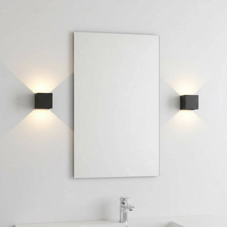 black wall bathroom lamp mounted either side of a mirror in a modern bathroom 