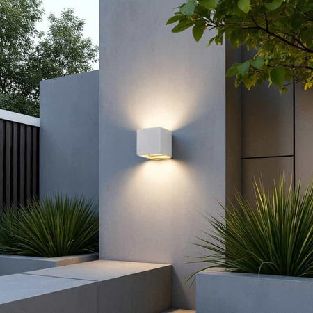 white up and down outside light mounted on a white wall outside a modern house 