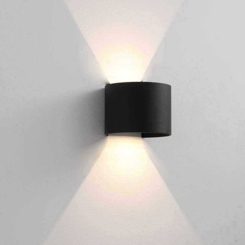 black up down outside light shown on a white wall 