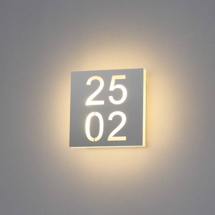 LED hotel room door number mounted on a white wall 