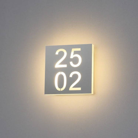 LED hotel room door number mounted on a white wall 