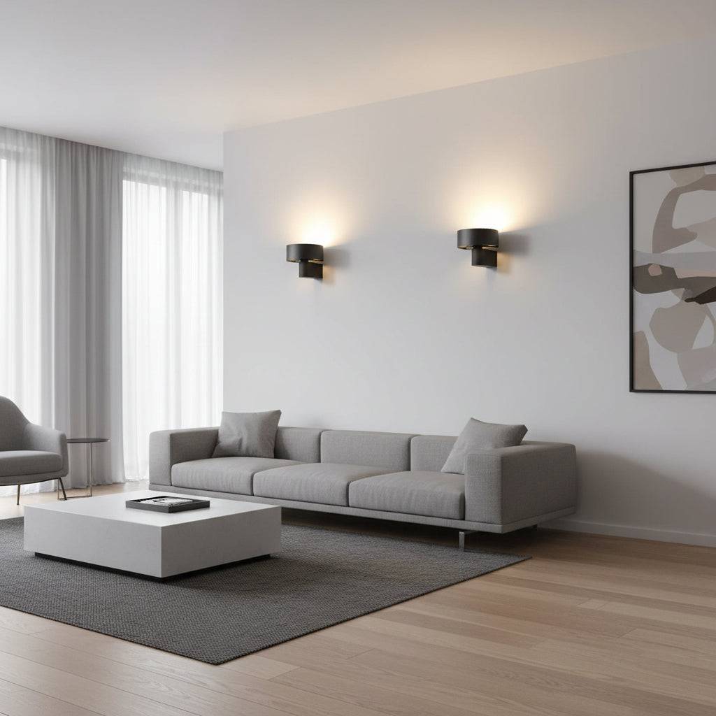 Black wall mounted interior light fixture on one wall above a sofa in a modern longe