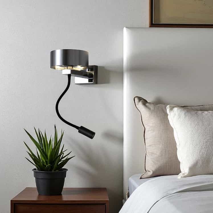 chrome bedside lamp with reading light installed next to the bed in a modern bedroom