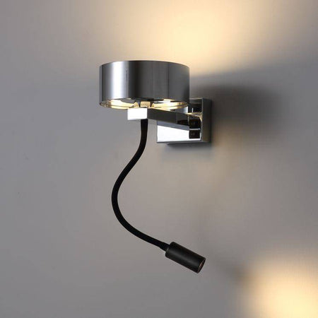 polished chrome bedside lamp with reading light mounted on a white wall