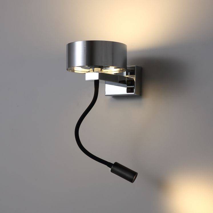 polished chrome bedside lamp with reading light mounted on a white wall