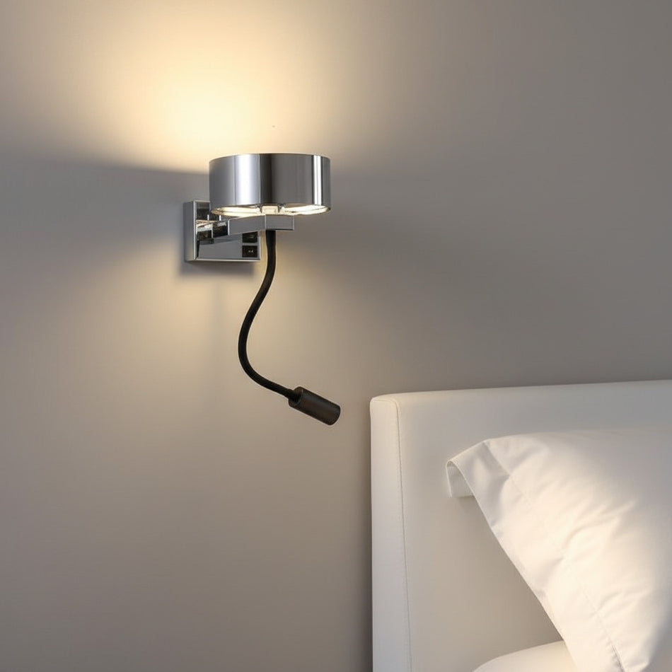 chrome bedside lamp with reading light mounted on the wall next to a bed. 