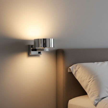 chrome bedside wall reading light mounted next to a bed