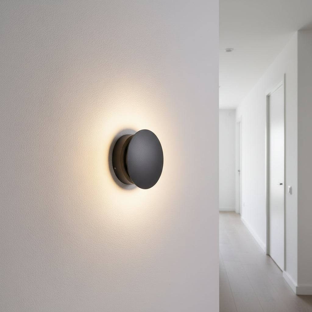Black inside wall light fixture on a wall leading to a hallway